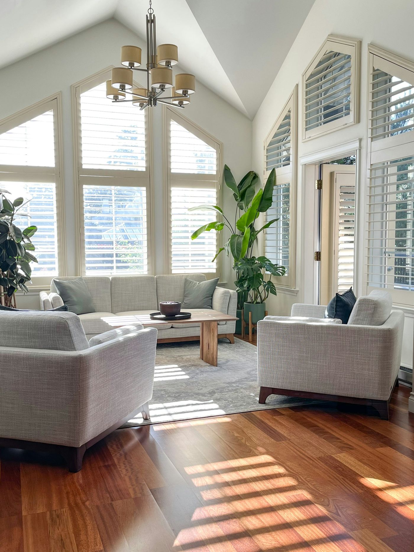 A bright, calm, organized living room filled with natural light