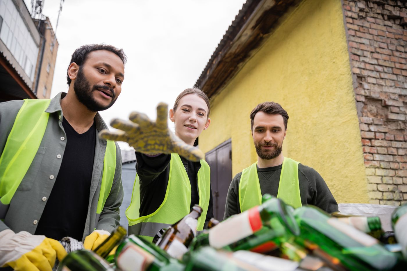 Recycling team sorting plastic bottles and reusable materials